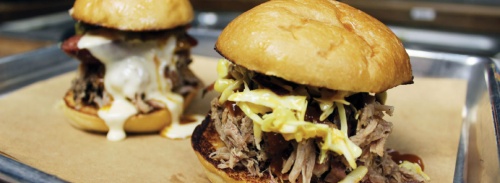 The Notorious P.I.G. and Tony Montana sliders at SLAB BBQ are topped with smoked meats and homemade sauce.