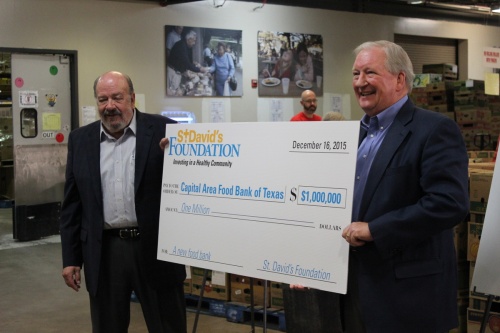 Earl Maxwell, right, presents a $1 million check to the Capital Area Food Bank in 2015.