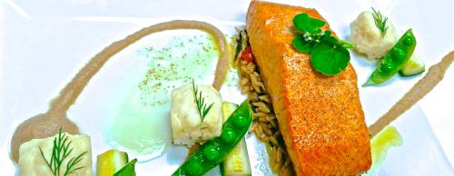 Smoked salmon ($27) is served with sunchoke puree, orzo with spinach pesto, citrus butter and glazed vegetables.