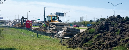 Workers ready a construction area on Dallas Parkway at the President George Bush Turnpike.