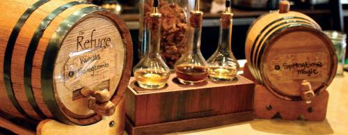 Co-owner Luis Padilla ages a variety of infused whiskeys in barrels that are stored at the bar.