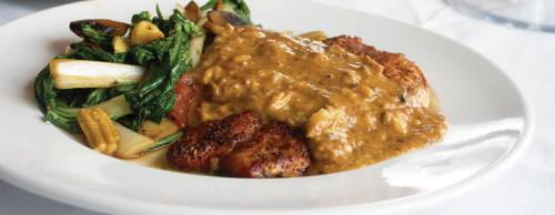 The blackened redfish dish is served in a chipotle crabmeat sauce with vegetables ($15.95).