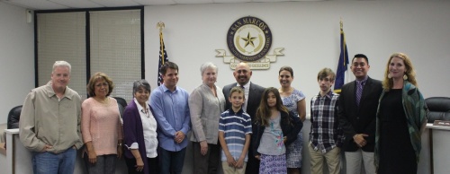 Michael A. Cardona (center) and his family joined the San Marcos CISD board of trustees for a picture shortly after Cardona was named the lone finalist for the district's superintendent position. 
