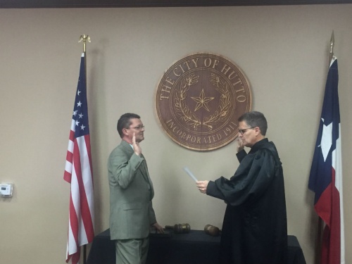 Tim Jordan is sworn in by Judge Bill Gravell at Hutto City Hall in March.