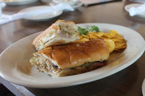 El Cubano con chicharitas ($9.99): The traditional Cuban sandwich contains Swiss cheese, ham, pork, mustard and pickles and is served with a side of plantain chips. (All photos by Sierra Rozen/Community Impact Newspaper)