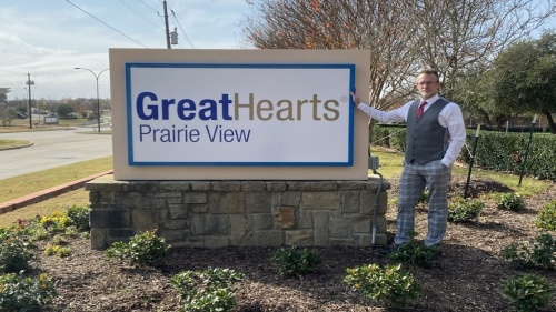 Great Hearts Prairie View headmaster standing next to the school's sign