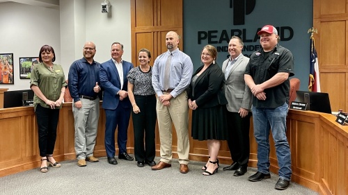 Larry Berger (fifth from left) stands with the Pearland ISD board of trustees after becoming the new superintendent of the district. (Andy Yanez/Community Impact Newspaper)