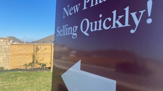 A sign reading "New Phase Selling Quickly!"