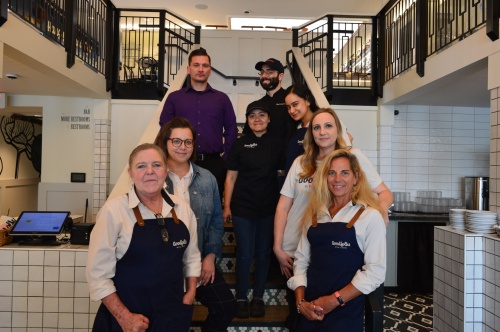 From left: Goodfolks staff, including Denette Mexedon, Jayme Austin, Justin Richard, Ana Osorin, Justin Manzi, Lina Sotto, Corinne Jarvis and Carol Gill, serve Southern-inspired food. (Hunter Terrell/Community Impact Newspaper)
