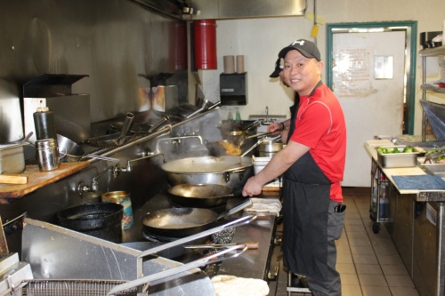 Andy Ke, an owner of the Great Wall of China, cooks in the restaurant's kitchen at 2176 Hillsboro Road, Franklin. (Martin Cassidy/Community Impact Newspaper) 
