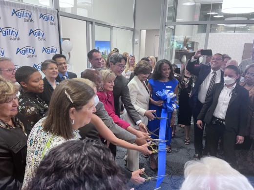 Lauren Sparks (center), founder, CEO and president of Agility Bank, was joined by Mayor Sylvester Turner, District C Council Member Abbie Kamin, acting Comptroller of the Currency Michael Hsu and a number of others for a May 23 ribbon cutting. (Sofia Gonzalez/Community Impact Newspaper)
