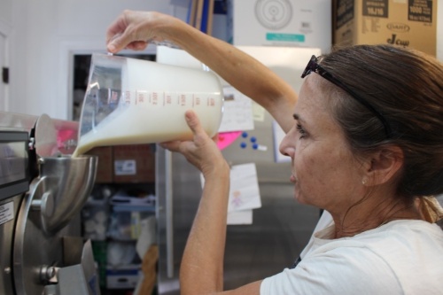 Owner Lorraine Featherston lines up locally sourced milk along with a puree of the flavor to make gelato, such as strawberry. Dottie’s keeps 12 flavors of gelato on rotation. (Jishnu Nair/Community Impact Newspaper)