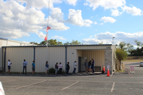 A line of voters extends out the door of the polling location at the Knights of Columbus Hall in New Braunfels. (Eric Weilbacher/Community Impact Newspaper)