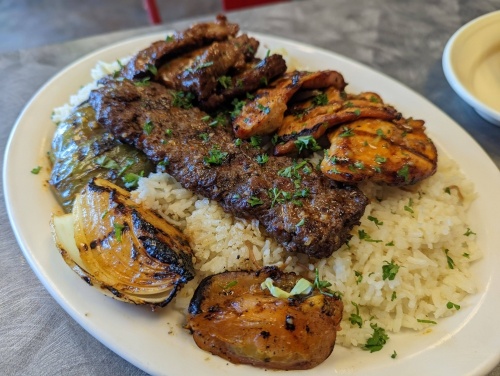 Kabob platter ($19.95): A combination of shish kabob and kafta kabob is served with rice, salad, hummus and pita. (George Wiebe/Community Impact Newspaper)