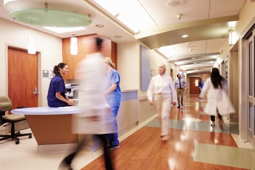 doctors and nurses walk around in a modern hospital setting