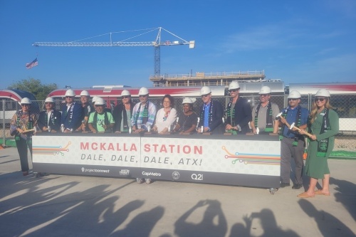 Community leaders pounded symbolic railroad tracks with mallets at a groundbreaking for McKalla Station on  July 18. (Jennifer Schaefer/Community Impact Newspaper)