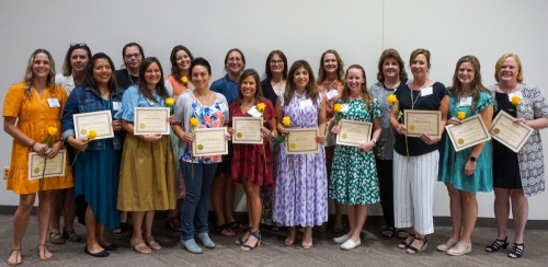 The 2022 Teachers of the Year from the New Braunfels area hold their certificates and yellow roses at the McKenna Events Center in New Braunfels. (Sierra Martin/Community Impact Newspaper)