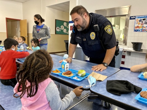North East ISD Police Officer John Trevino visits with NEISD elementary school students as part of the district’s Meals for Shields program, which fosters positive relationships within the school community. (Courtesy North East ISD)
