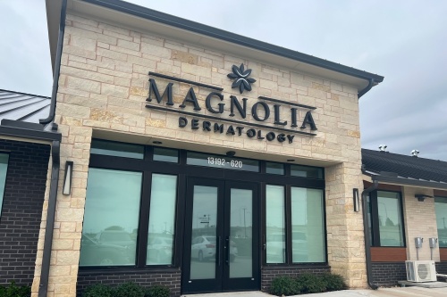 Office building with front sign for Magnolia Dermatology.
