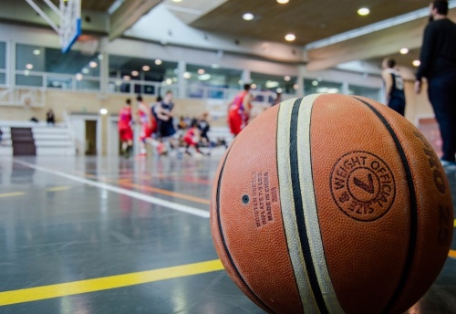 close up of basketball with players in the background