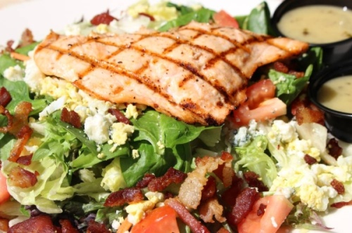 The cobb salad ($8.50) contains diced avocado, tomatoes, blue cheese crumbles, eggs and a house remoulade. Customers can also add their choice of protein: chicken, shrimp, ahi tuna or salmon ($3-$6). (Renee Yan/Community Impact Newspaper)