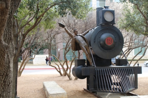 "Frisco's First" is a sculpture of a 1900s-era farmer holding onto a train engine to celebrate the arrival of the railroad to Frisco. It is located in front of the George A. Purefoy Municipal Complex. (William C. Wadsack/Community Impact Newspaper)