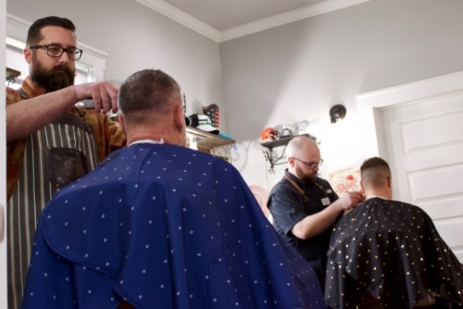 From left: Will Santoliquido and Dennis Burky cut hair at Round Rock Barber Shop. (Taylor Jackson Buchanan/Community Impact Newspaper)