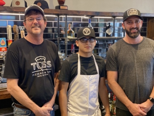 From left, Scott Leehner, Toss Pizzeria general manager for the Bee Cave location; Trinidad Ramirez, kitchen manager for the Bee Cave location; and Justin DeLaCruz, co-owner, stand in front of the restaurant's bar. 
Photos by Brian Rash