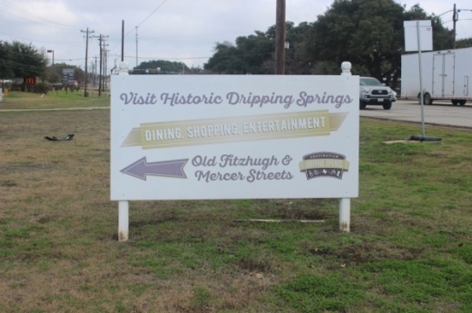 A photo of a sign that reads "Visit Historic Dripping Springs."