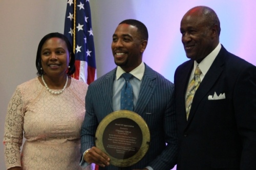 Chauncy Glover (center) accepts an award from Ann and T.J. Wilkerson. (Andy Li/Community Impact Newspaper)