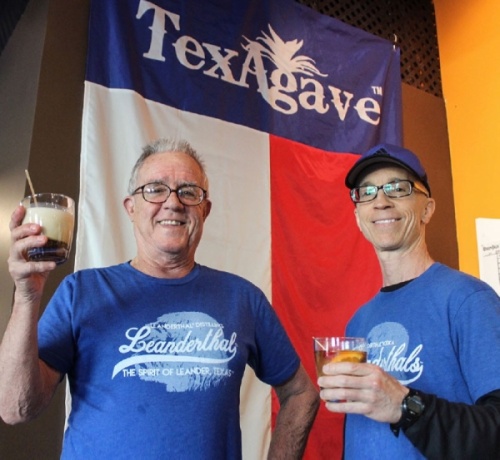 Leanderthal Distilling founder Scott Calame (right) raises a glass with bartender Jim Nunn. (Brian Perdue, Community Impact Newspaper)