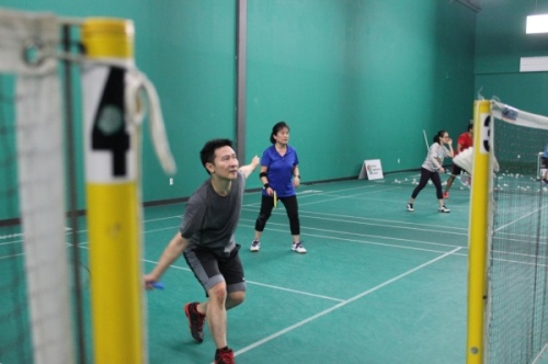 A student gets into position to hit the birdie in a class at Plano Badminton Center. (Daniel Houston/Community Impact Newspaper)