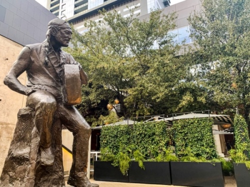 A statue of Willie Nelson sits across from Austin City Hall at the corner of Lavaca and Second streets. (Emma Freer/Community Impact Newspaper)