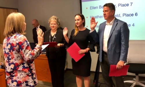 From left: Eanes ISD trustees Ellen Balthazar, Heather Sheffield and James Spradley take the oath of office following the May 2019 election. (Sally Grace Holtgrieve/Community Impact Newspaper)