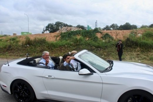 Mike Heiligenstein (left) takes the last vehicular trip on the Montopolis Bridge in East Austin in October 2018. Heiligenstein is stepping down from executive director of the Central Texas Regional Mobility Authority, which closed the historic bridge as part of its US 183 South toll project. The bridge is being refurbished and will be used by bicyclists and pedestrians when it reopens. (Amy Denney/Community Impact Newspaper)