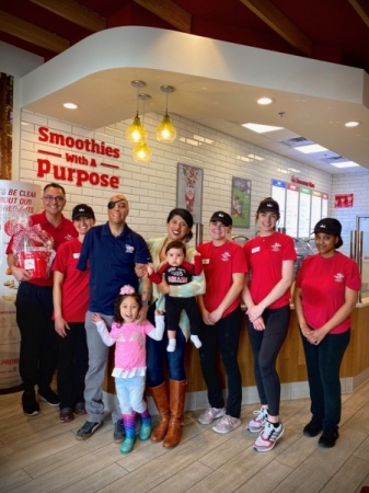 Sgt. (Ret.) Mario Lopez and his family accept the check at Smoothie King. (Courtesy Amy Lohse)
