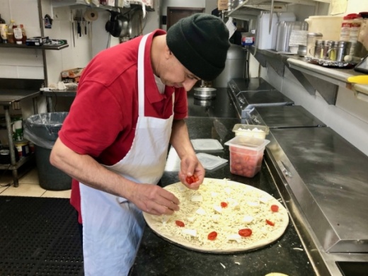 Abed Yaghi makes a margherita pizza. (Sally Grace Holtgrieve/Community Impact Newspaper)