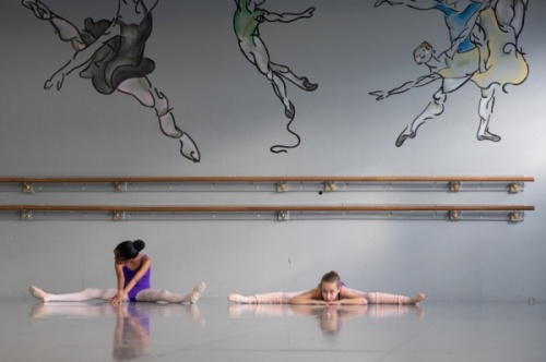 Level III ballet students take part in stretches during class. Before reaching Level IV, students must master technical skills and prove their physical and mental focus, according to the academy's syllabus. (Liesbeth Powers/Community Impact Newspaper)