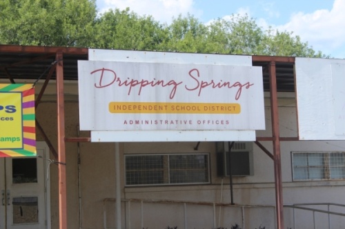 A photo of a sign that reads "Dripping Springs Independent School District Administrative Offices."