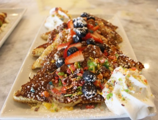 Fruity Pebbles French Toast ($11.99) consists of sourdough bread coated with Fruity Pebbles and drizzled with vanilla cream sauce.