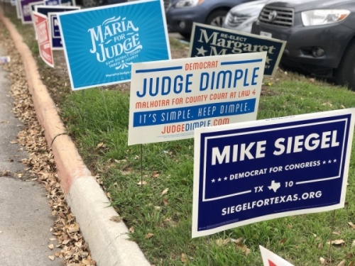 Candidate signs line the road leading into Austin Community College's Highland campus on Feb. 23 during the early voting period in Travis County. Jack Flagler/Community Impact Newspaper