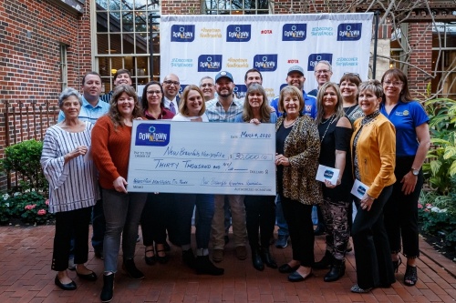Nonprofit vendors accepted a $30,000 check to assist is replacing their Wurstfest equipment. (Courtesy Mikie Farias/New Braunfels Downtown Association)