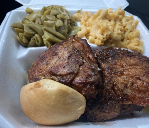 The restaurant offers a barbecue sampler, which includes two ribs, chicken and a porkchop, three sides, a roll and iced tea. (Makenzie Plusnick/Community Impact)