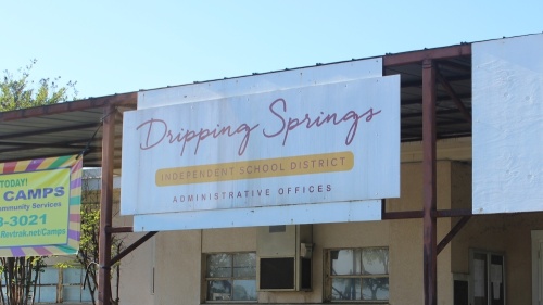 A photo of a sign that reads "Dripping Springs Independent School District Administrative Offices"