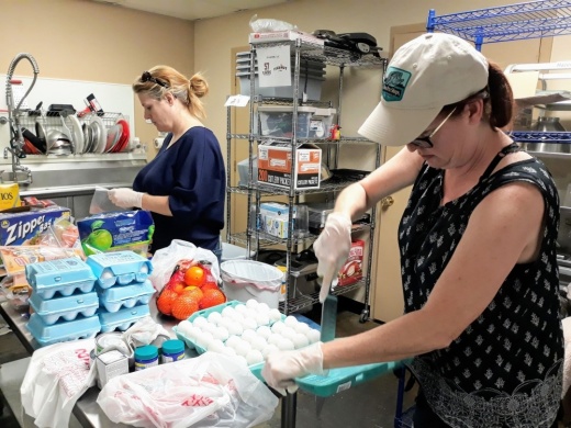 Volunteers from the Cypress Area Eats Facebook group sort grocery donations and purchases to deliver to their neighbors. (Courtesy Cypress Area Eats)