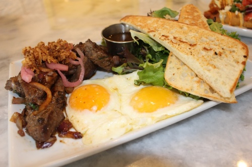 Vietnamese Steak & Eggs ($14.99) from Toast Breakfast Brunch Lunch is made with locally sourced, marinated, center-cut top sirloin and served with two eggs, a side salad and La Baccia toast. (Beth Marshall/Community Impact Newspaper)
