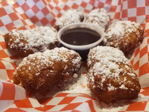 Beignets with chocolate sauce ($5.95) (Ali Linan/Community Impact Newspaper)