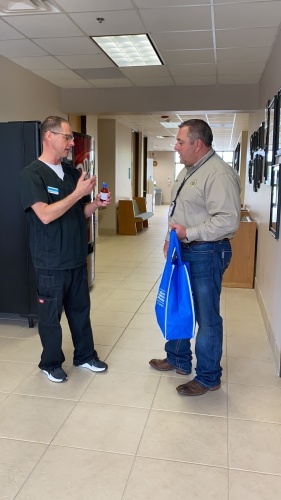 Steve Hoffart, owner of Magnolia Pharmacy, has donated hand sanitizer his pharmacy made to Montgomery County Precinct 5 Constable Chris Jones (right). (Courtesy PCCA)