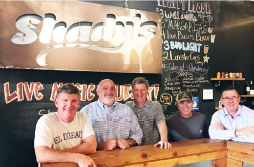 Co-owner of Shady's Burgers & Brewhaha Greg Cooney (left) is reporting a loss of revenue and employee furloughs due to the coronavirus. (Olivia Lueckemeyer/Community Impact Newspaper)