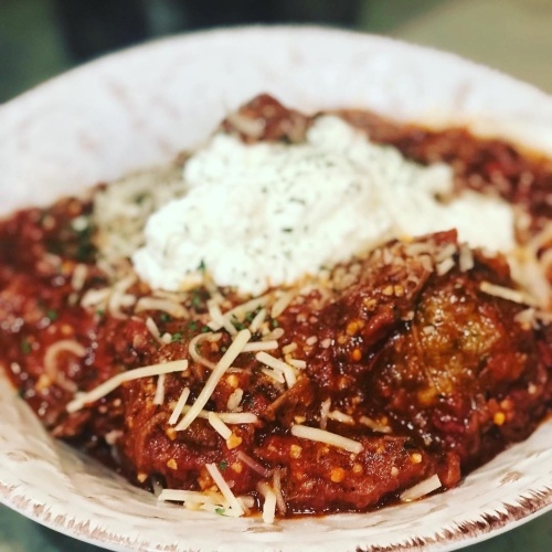 A half-pan portion of meatballs with bolognese, meatballs, fresh mozzarella and ricotta and baguette is $45 and feeds four to six people. (Courtesy Mason & Dixie)